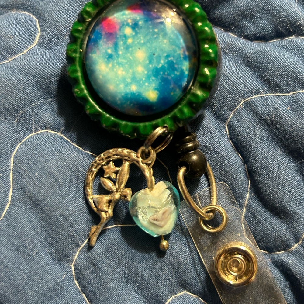 Badge reel made with Glass cabochon with bead and charms on an alligator clip.